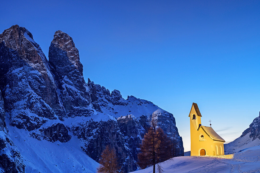 Illuminated chapel in front of rock towers of the Sella group, Dolomites, Dolomites World Heritage Site, South Tyrol, Italy