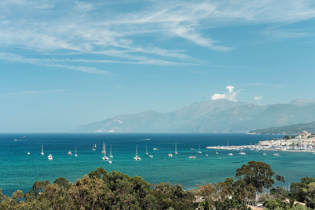 Saint Florent harbor, behind it Cap Corse, Corsica, France.