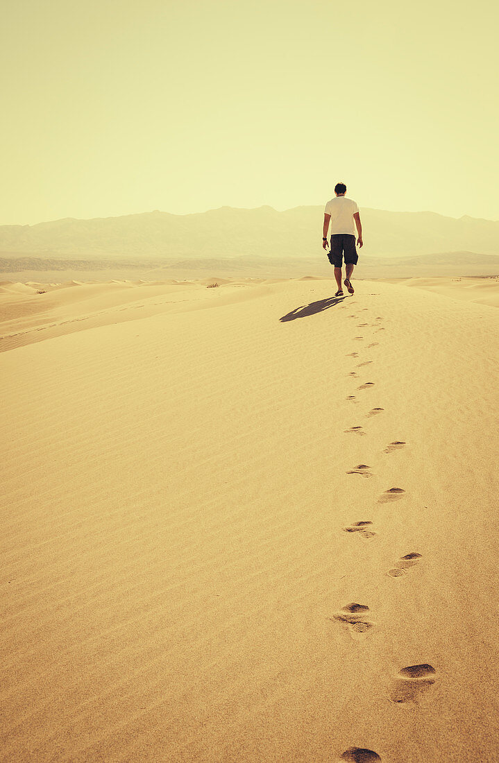 Man in the Mesquite Flat Sand Dunes, Death Valley National Park, California, USA