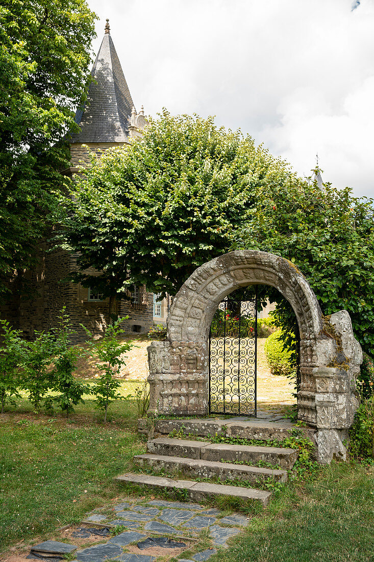 Historic stone gate to the garden in the castle park of Rochefort en Terre, Morbihan department, Brittany, France, Europe