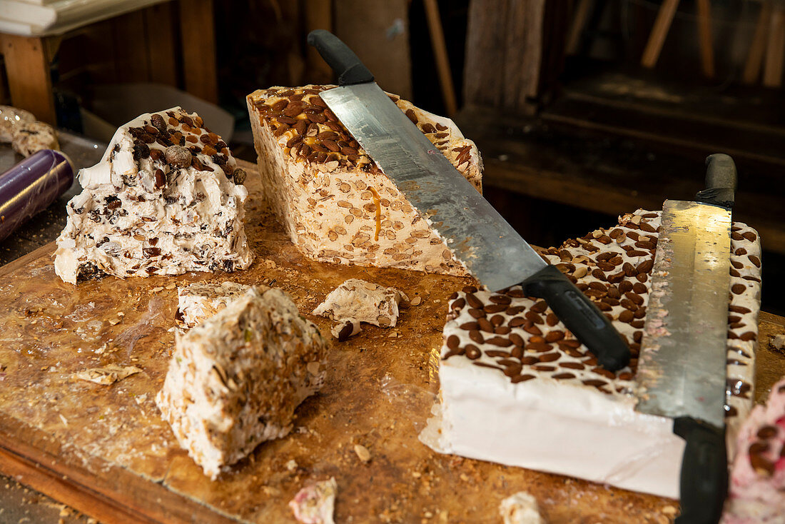 Bretonische Spezialität Nougat mit Honigkaramell und Butter auf großem Holzbrett, Rochefort en Terre, Departement Morbihan, Bretagne, Frankreich, Europa