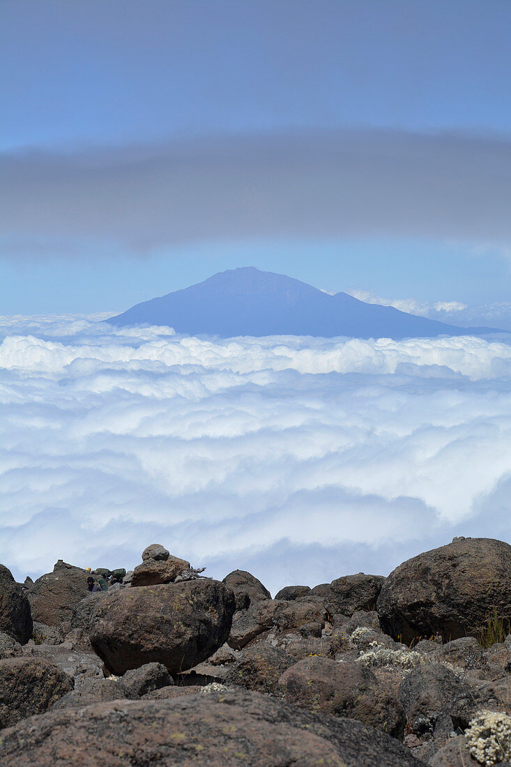 Tanzania, East Africa, Mount Meru in the sea of clouds, view from Kilimanjaro to the summit, rocky abyss on the edge of the hiking trail