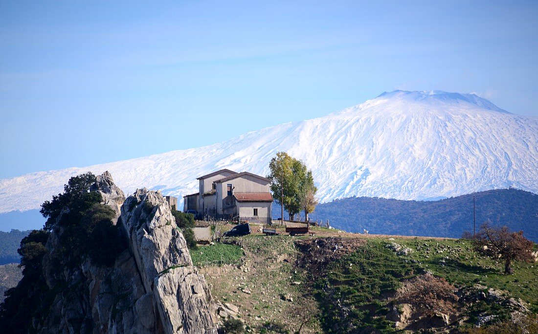 View over a farmhouse to Mount Etna near Enna in the center, Sicily, Italy