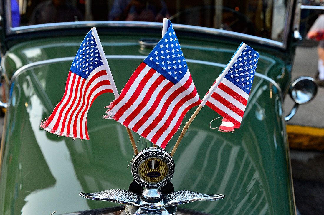 Classic car decorated with flags during a folk festival in Nevada City, California, USA