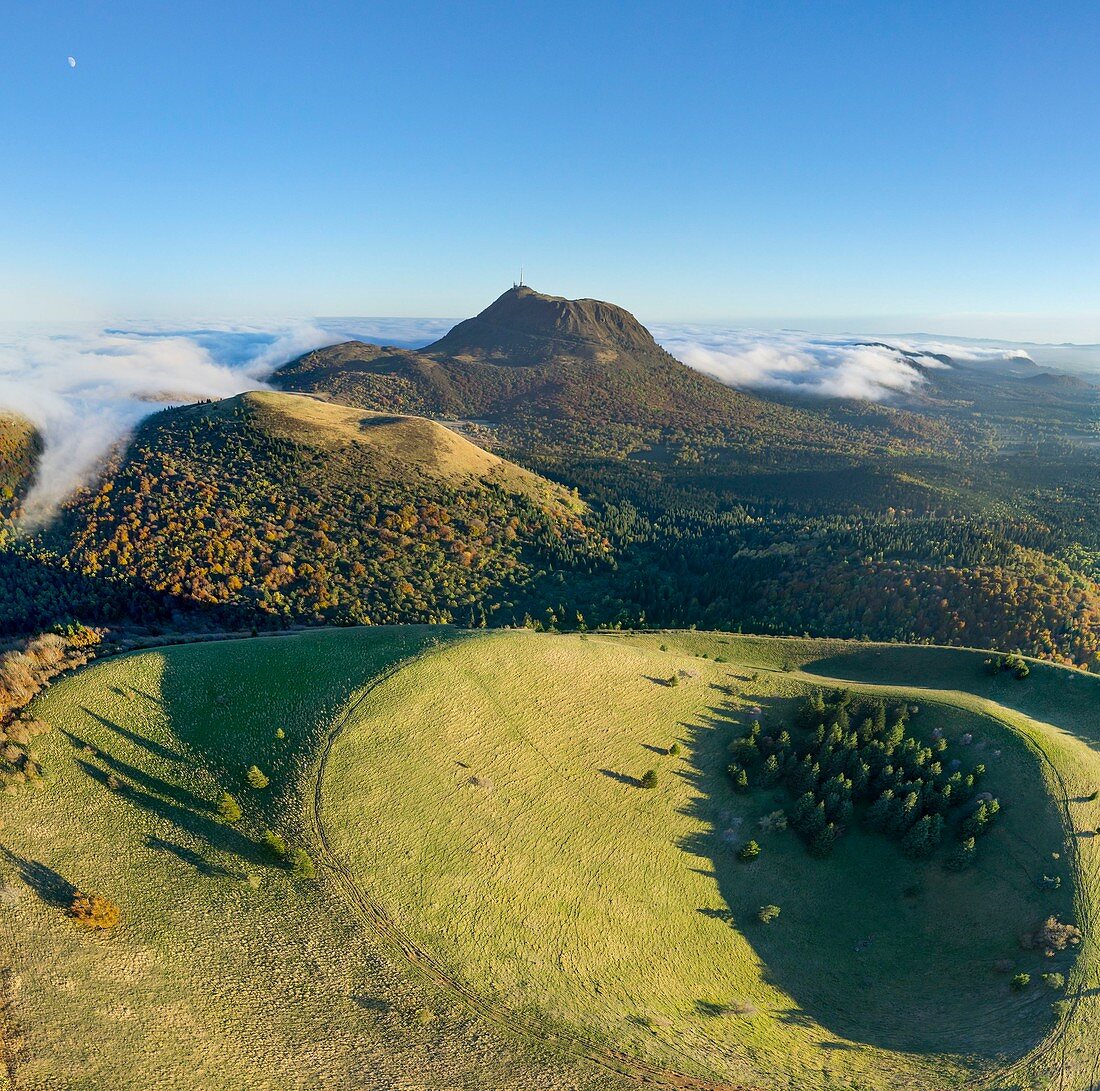 France, Puy de Dome, area listed as World Heritage by UNESCO, Ceyssat, Chaine des Puys, Regional Natural Park of the Auvergne Volcanoes, summit of Puy de Come volcano and Puy de Dome in the background (aerial view)
