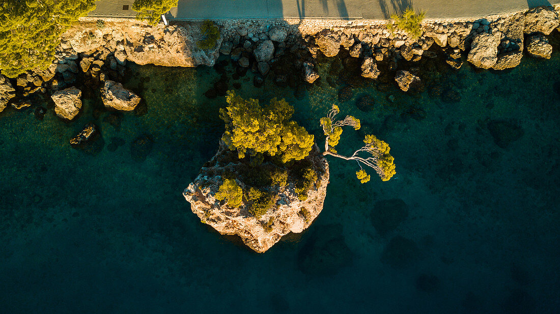 Blick von oben auf felsige Insel mit Bäumen, Brela, Kroatien