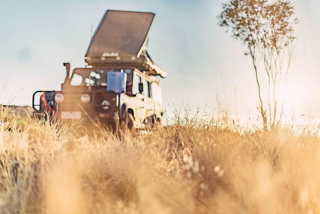 Off-road vehicle in the morning light in the Pilbara in Western Australia, Australia, Oceania;