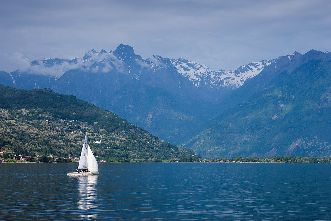 Lake Como with mountains and sailboat, Switzerland