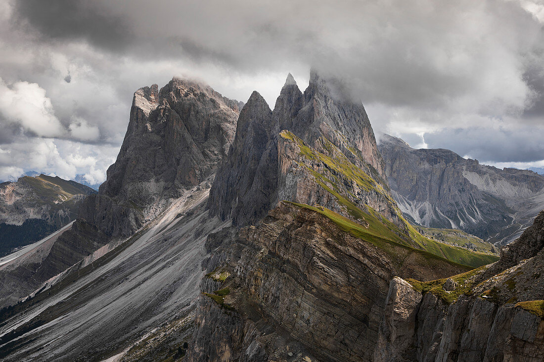 Dramatic Seceda mountainside with thick clouds in the Dolomites near Ortisei, South Tyrol