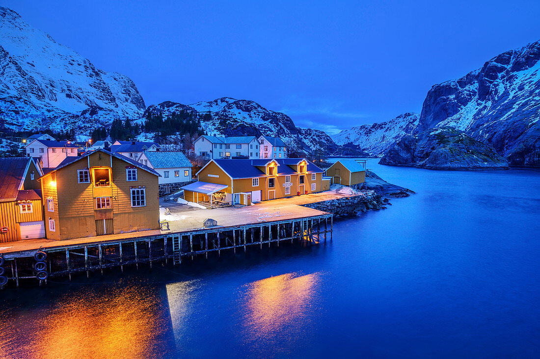 Illuminated fishermen's houses in the port of Nusfjord, Nusfjord, Lofoten, Nordland, Norway