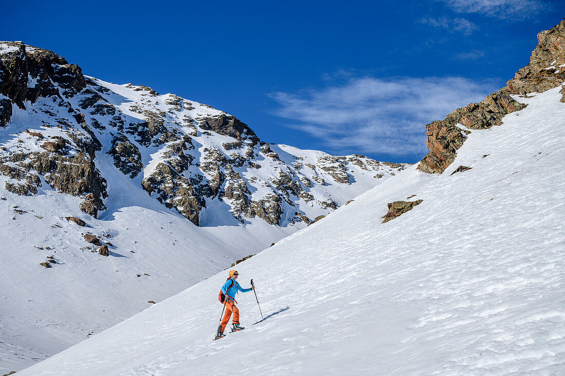 Woman on ski tour climbs to Plereskopf, Plereskopf, Matscher Valley, Ötztal Alps, South Tyrol, Italy