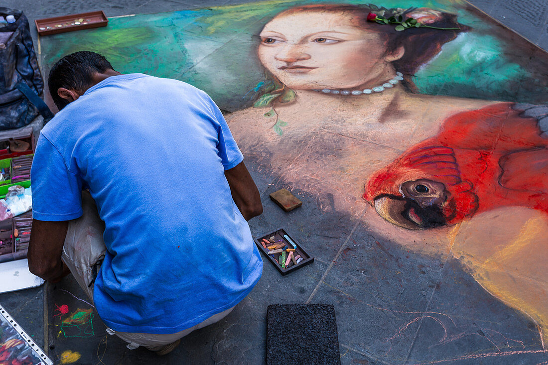 An artist paints the streets of Florence, Italy