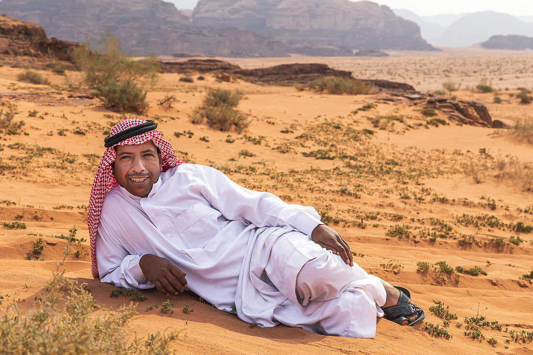 Ein Beduine liegt in der Wüste im Wadi Rum, Jordanien