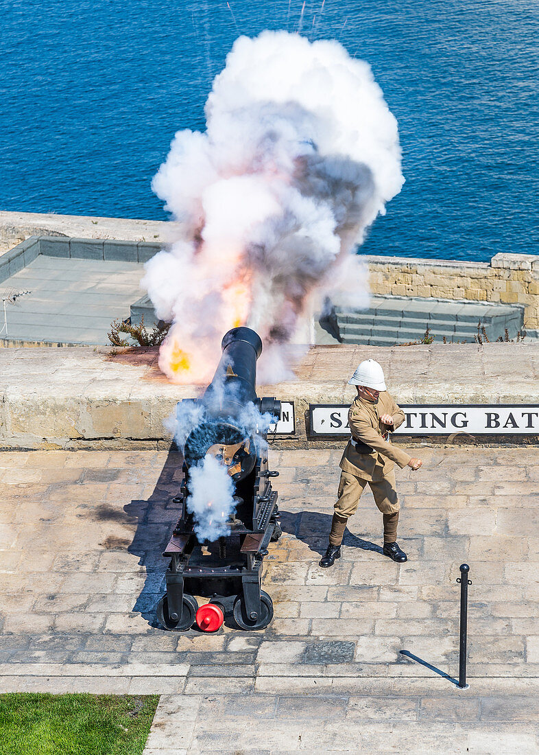 Cannon fires in the Barrakka Gardens in Valletta, Malta