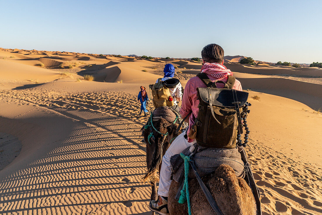 Tourists ride through Erg Chebbi, Morocco