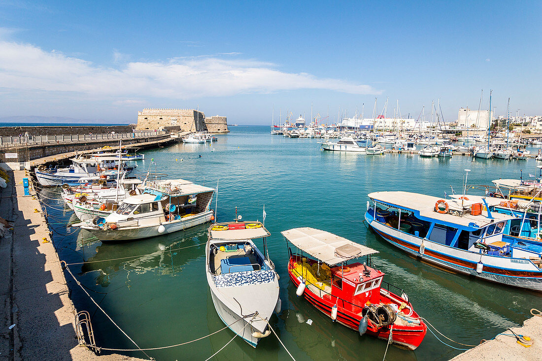 Boats on the breakwater in the port of Heraklion, north Crete, Greece