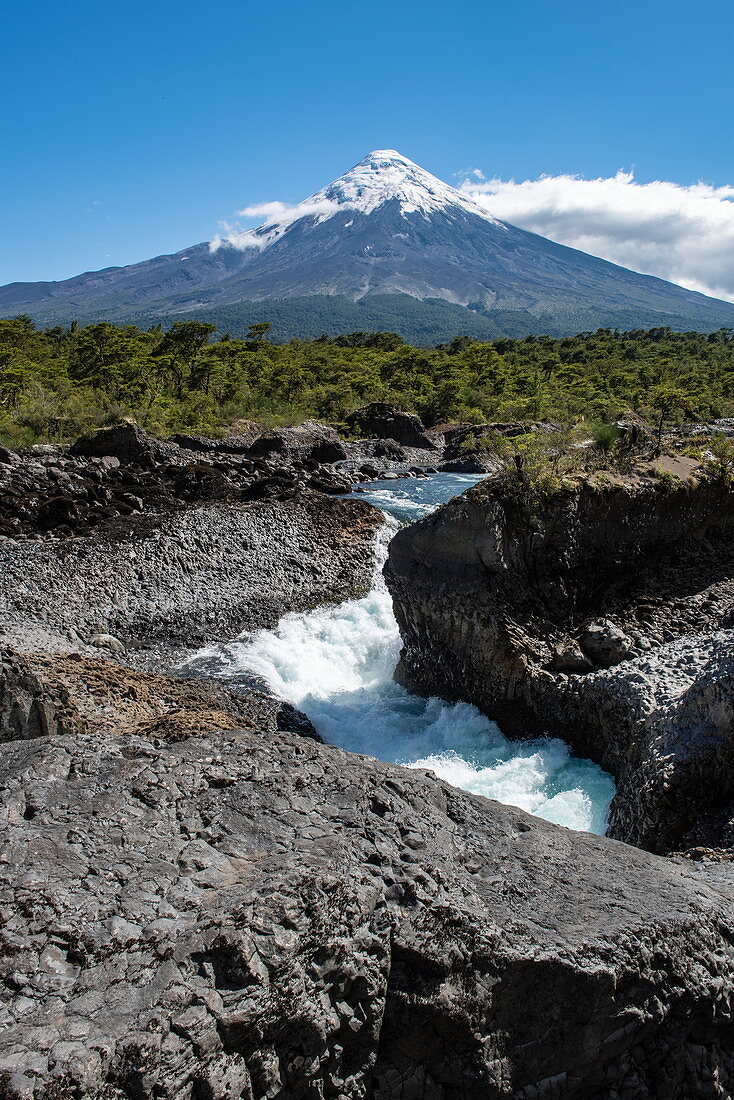 The famous Petrohue cascades with the snow-capped Osorno volcano in the distance, near Puerto Montt, Los Lagos, Patagonia, Chile, South America
