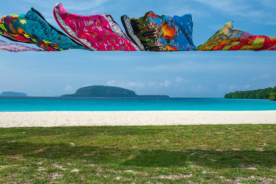 Bunte Stofftücher als Touristen-Souvenirs hängen auf einer Leine am Strand, Insel Espiritu Santo, Vanuatu, Südpazifik