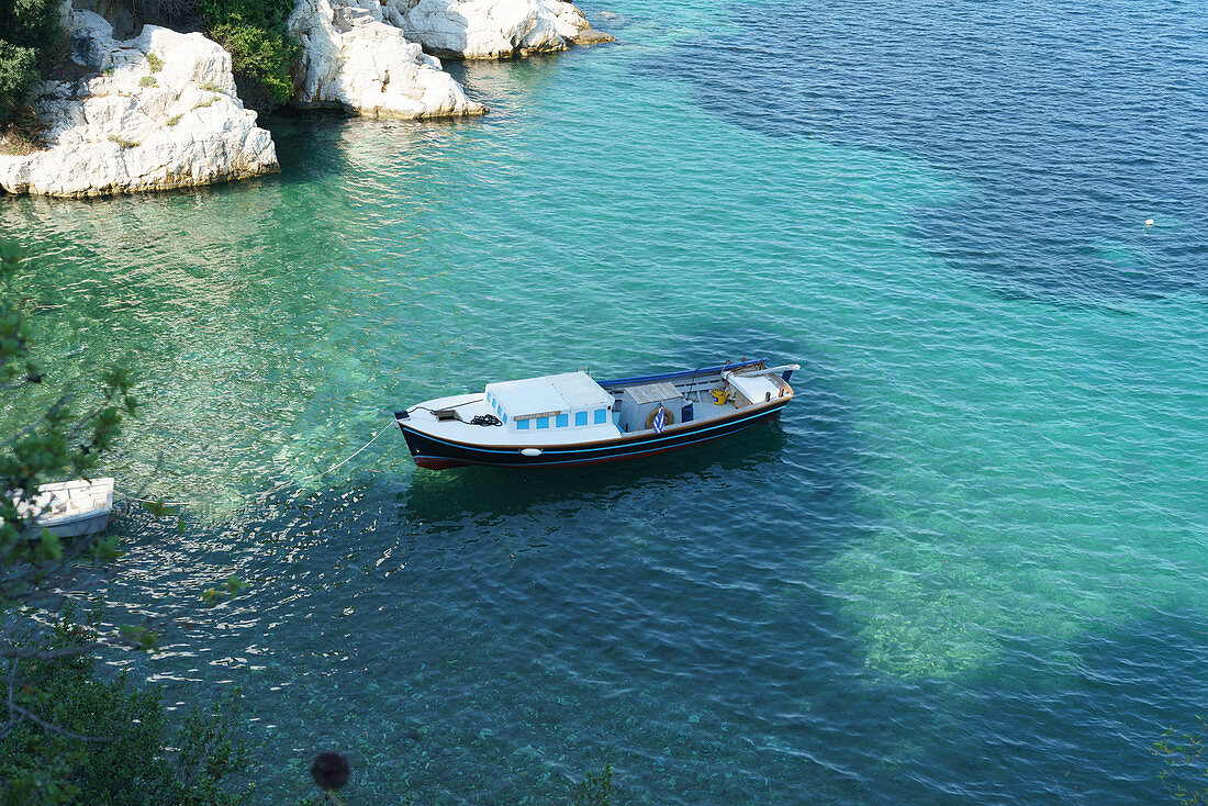 Small fishing boat in front of the capital of Skiathos island, Greece