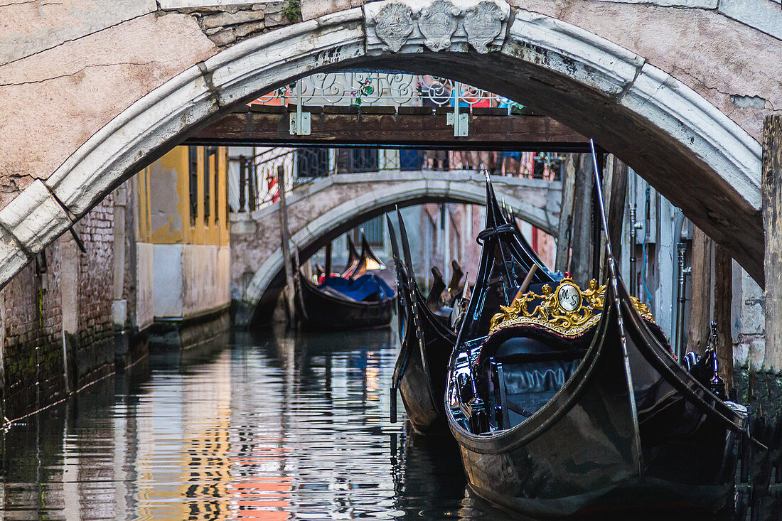 The typical Venetian gondolas in the city canals, Venice, Italy