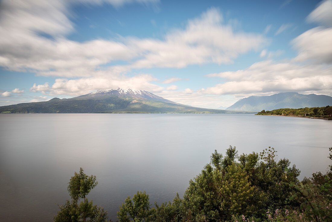 View of the cloud-covered Osorno volcano, Llanquihue Lake, Region de los Lagos, Chile, South America