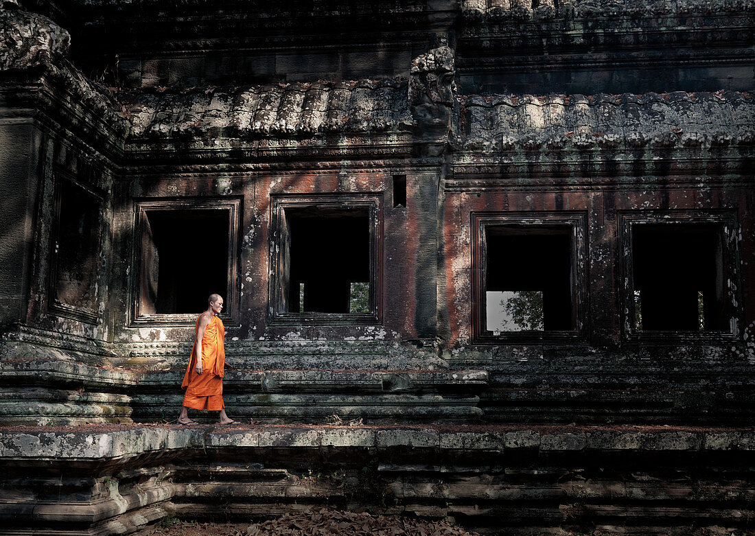 Siem Reap, Cambodia - January 19, 2011: A monk in his orange robe at the Angkor Complex.