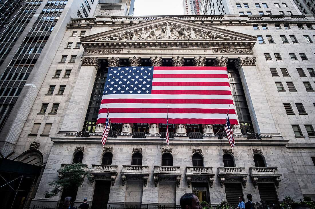 New York, United States of America - July 8, 2017. The American flag hanging in front of the New York Stock Exchange building in the famous Wall Street.