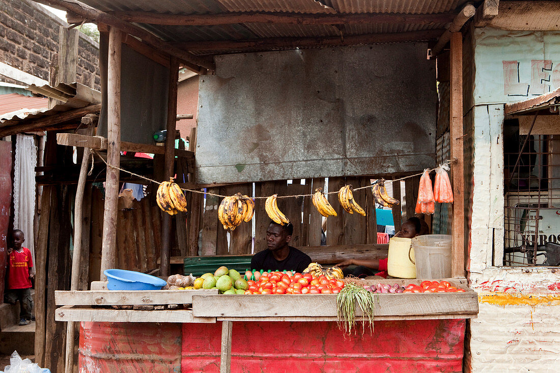 Kenyans at his fruit and vegetable stall in the slum, Eastleigh, Nairobi, Kenya