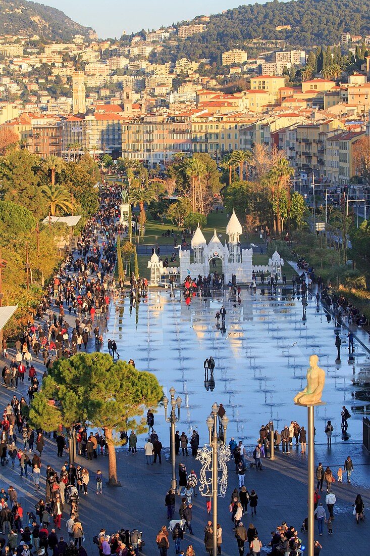 France, Alpes-Maritimes, Nice, the Promenade du Paillon, the reflecting pool of 3000 m2 and the fountains of the Place Massena, overlooking the clock tower of the former convent of brothers minors of St. Francis