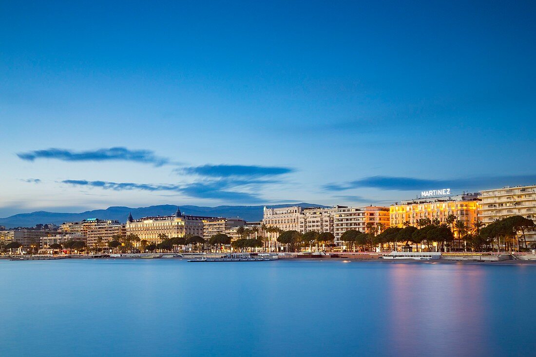 France, Alpes-Maritimes, Cannes, the Croisette and its palaces Carlton and Martinez at twilight