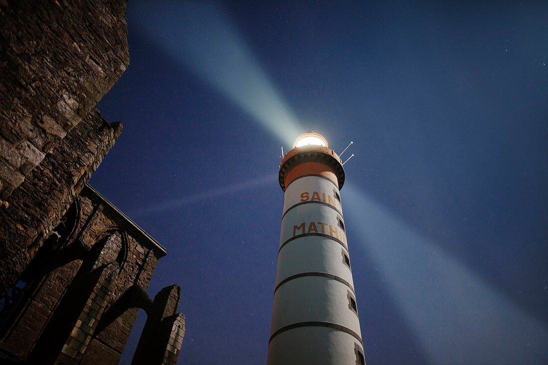 France, Finistere, Plougonvelin, Saint Mathieu point, The Saint Mathieu lighthouse rays in the night, listed as Historical Monument