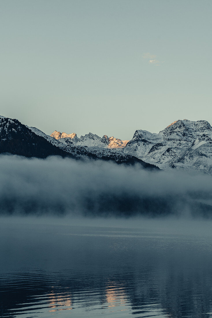 Lake Silvaplana at fog in the sunrise in the Upper Engadine, Sankt Moritz im Engadin, Switzerland