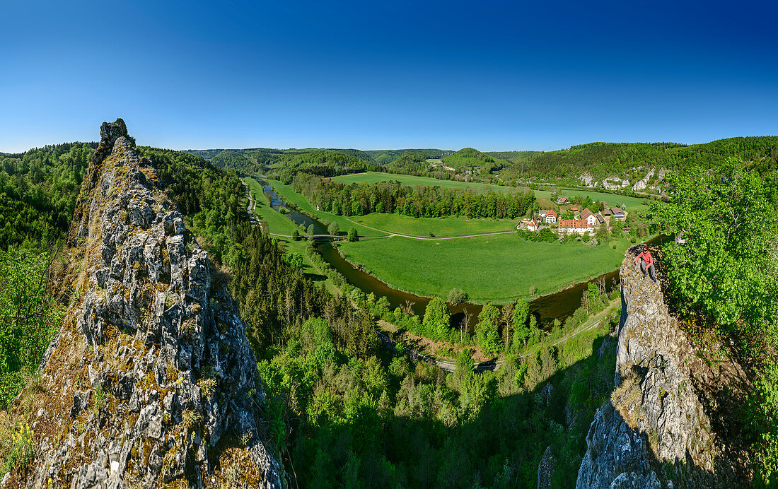 Panorama with woman sitting on rock tower, Danube in the background, Upper Danube Valley, Danube Cycle Path, Baden-Württemberg, Germany