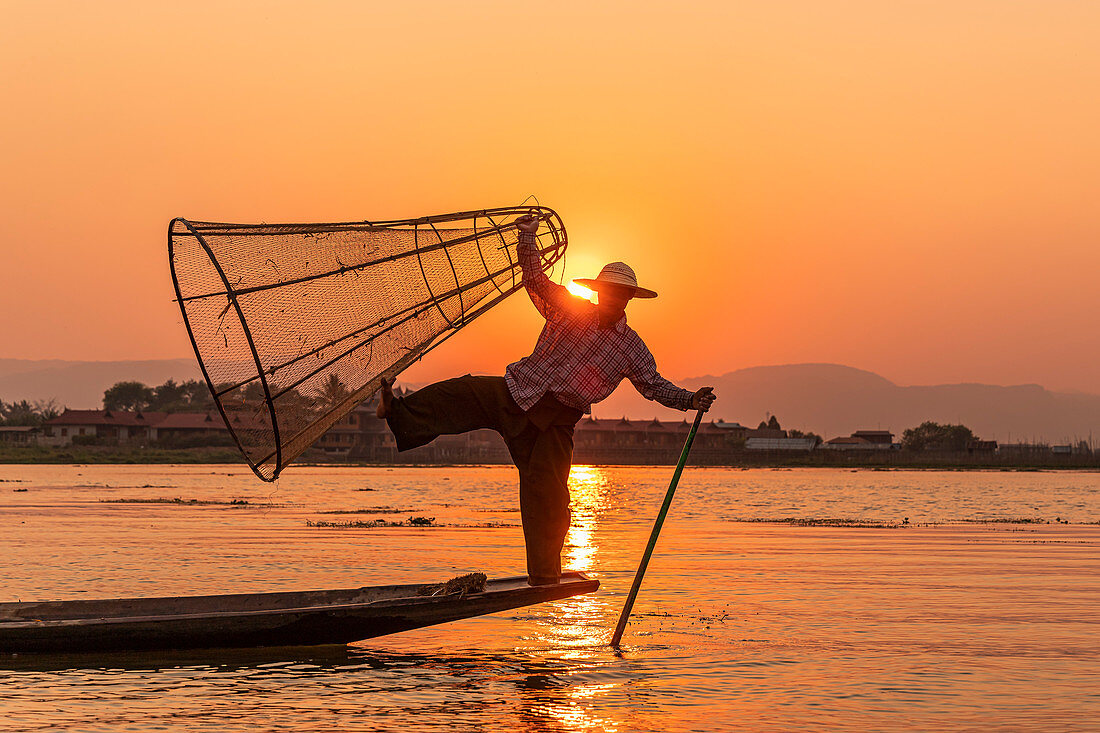 One-leg rower on Inle Lake at sunset on boat trip, Nyaung Shwe, Myanmar