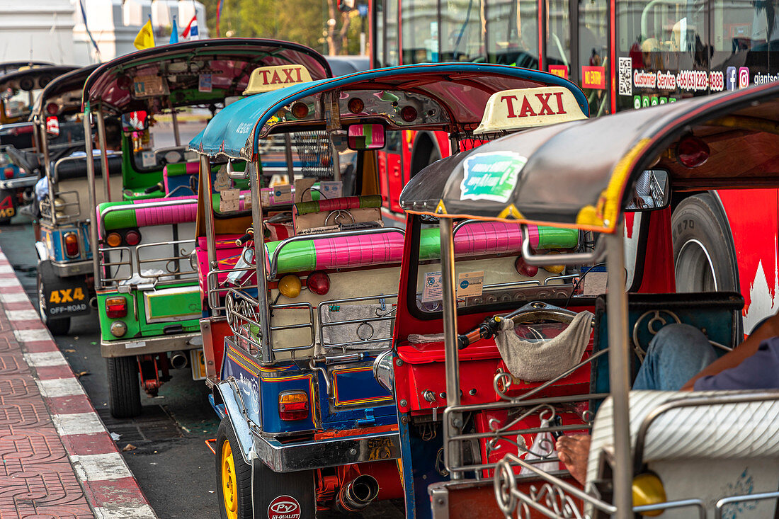 Tuk Tuk taxis in front of the Grand Palace, Bangkok, Thailand