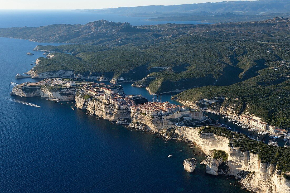 France, Corse du Sud, Bonifacio, the limestone cliffs, the citadel and the old town, the rock called Grain de Sable in the foreground (aerial view)