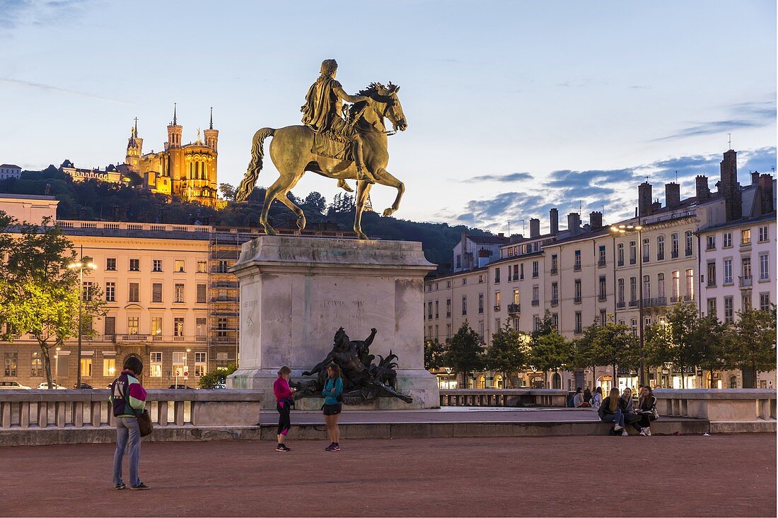 France, Rhone, Lyon, historical site listed as World Heritage by UNESCO, equestrian statue of Louis XIV on place Bellecour (Bellecour Square) and Notre Dame de Fourviere Basilica