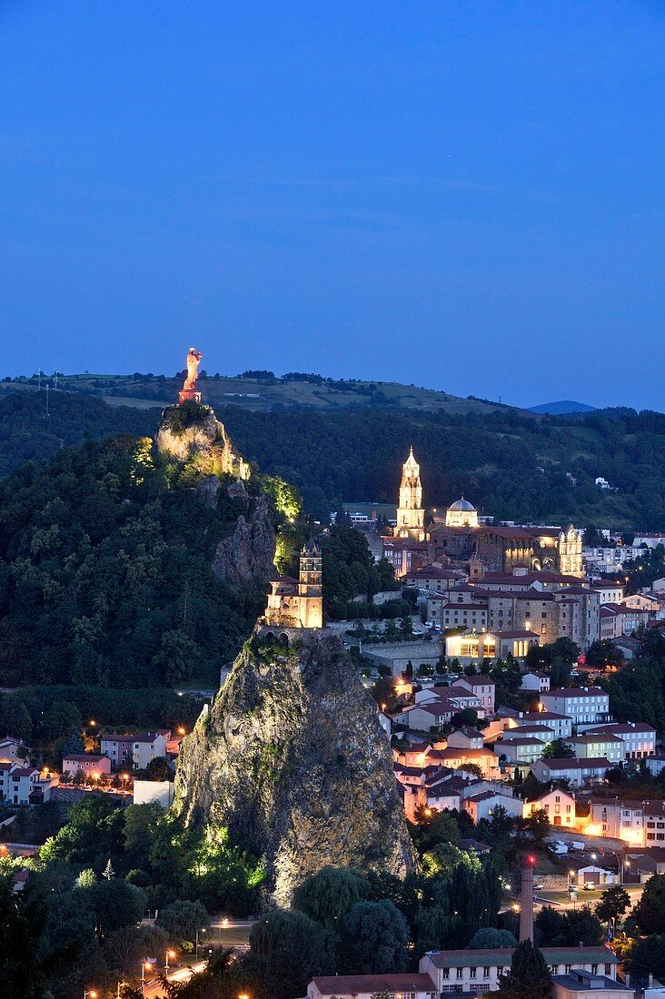 France, Haute Loire, Le Puy en Velay, a stop on el Camino de Santiago listed as World Heritage by UNESCO, overview of the city with Notre Dame de France statue (1860) at the top of on Rocher Corneille on the left, the Saint Michel of Aiguilhe chapel and 12th century Notre Dame de l'Annonciation Cathedral on the right