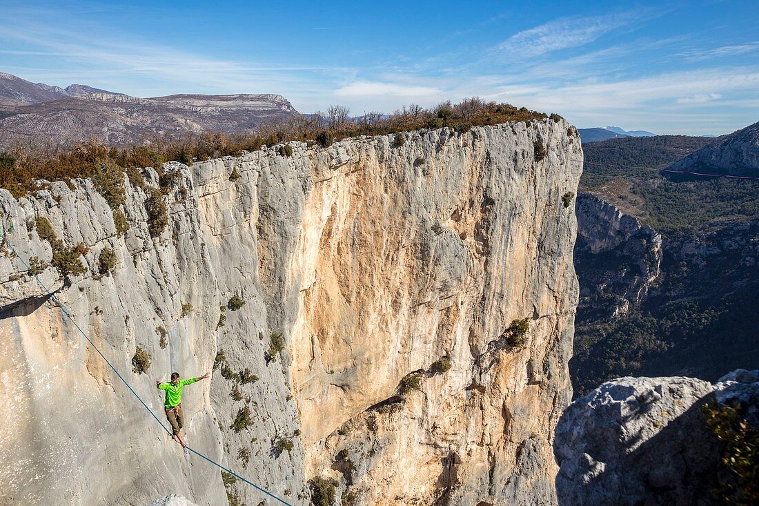 France, Alpes de Haute-Provence, regional natural reserve of Verdon, Grand Canyon of Verdon, a young man walks balance over the space on a highline of 25m in the circus of Sordidon there