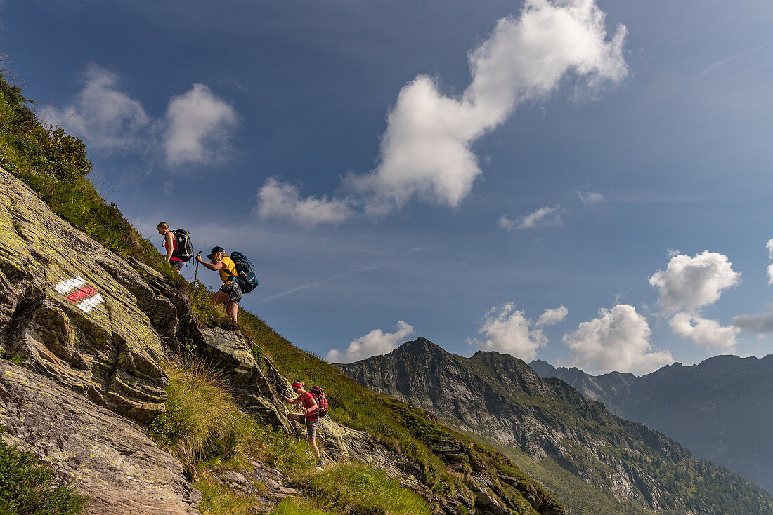 Female hikers climb to the Bochette de la Froda, Trekking del Laghetti Alpini, Ticino, Switzerland