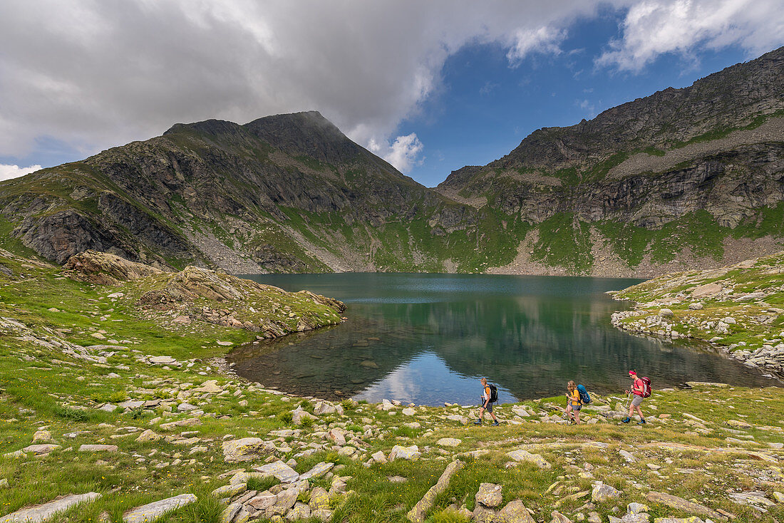 Hikers on Lago Nero, Trekking del Laghetti Alpini, Ticino, Switzerland