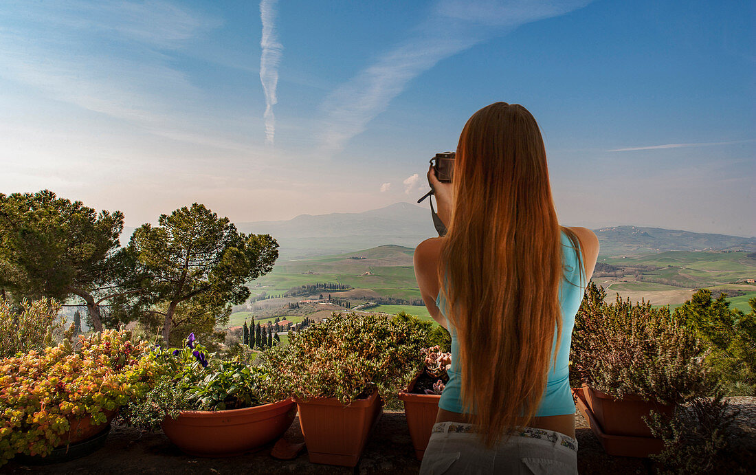 Woman taking photograph of hills