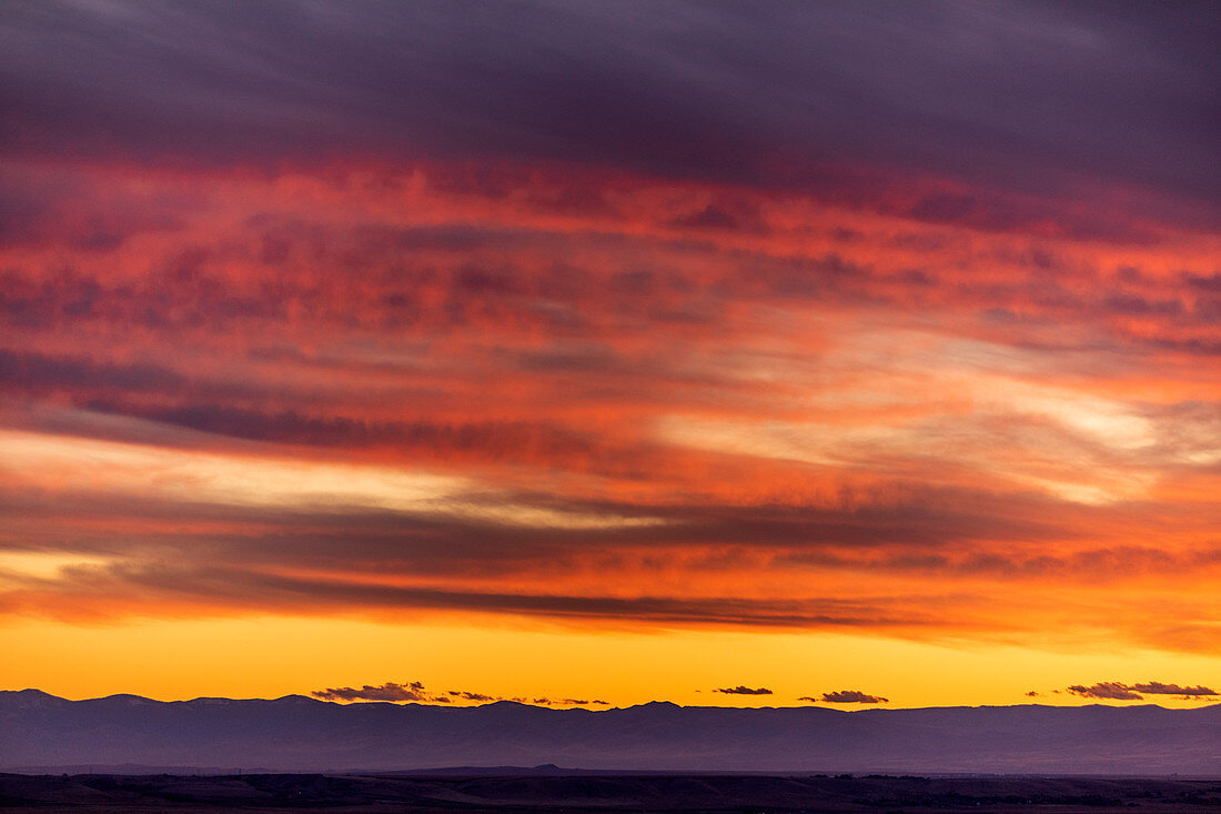 Silhouette of hills under dramatic sunset sky