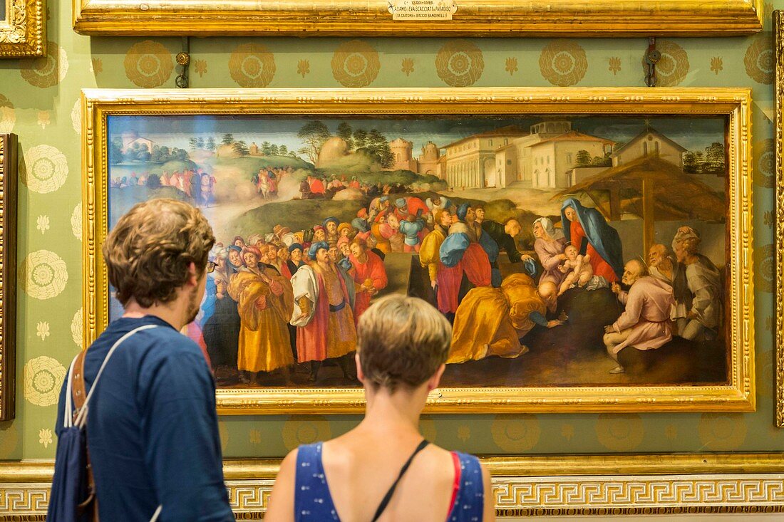 Italy, Tuscany, Florence, historical center listed as World Heritage by UNESCO, couple looking at the chart the Adoration of the Magi by Jacopo Pontormo exposed to the Palatine Gallery in the Pitti Palace