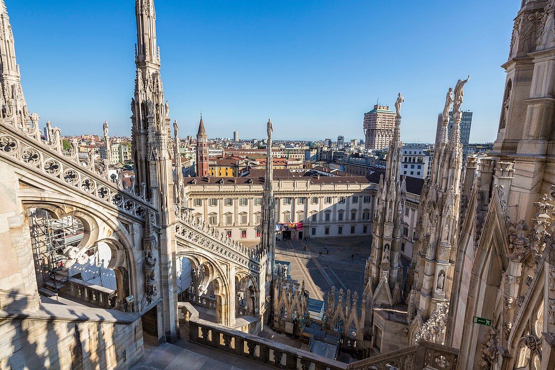 Italy, Lombardy, Milan, the arrows and statues of Duomo seen since the terrace situated on the roof of the cathedral with a view of the Palazzo Reale museum, the church San Gottardo in Corte or San Gottardo a Palazzo and the tower Velasca