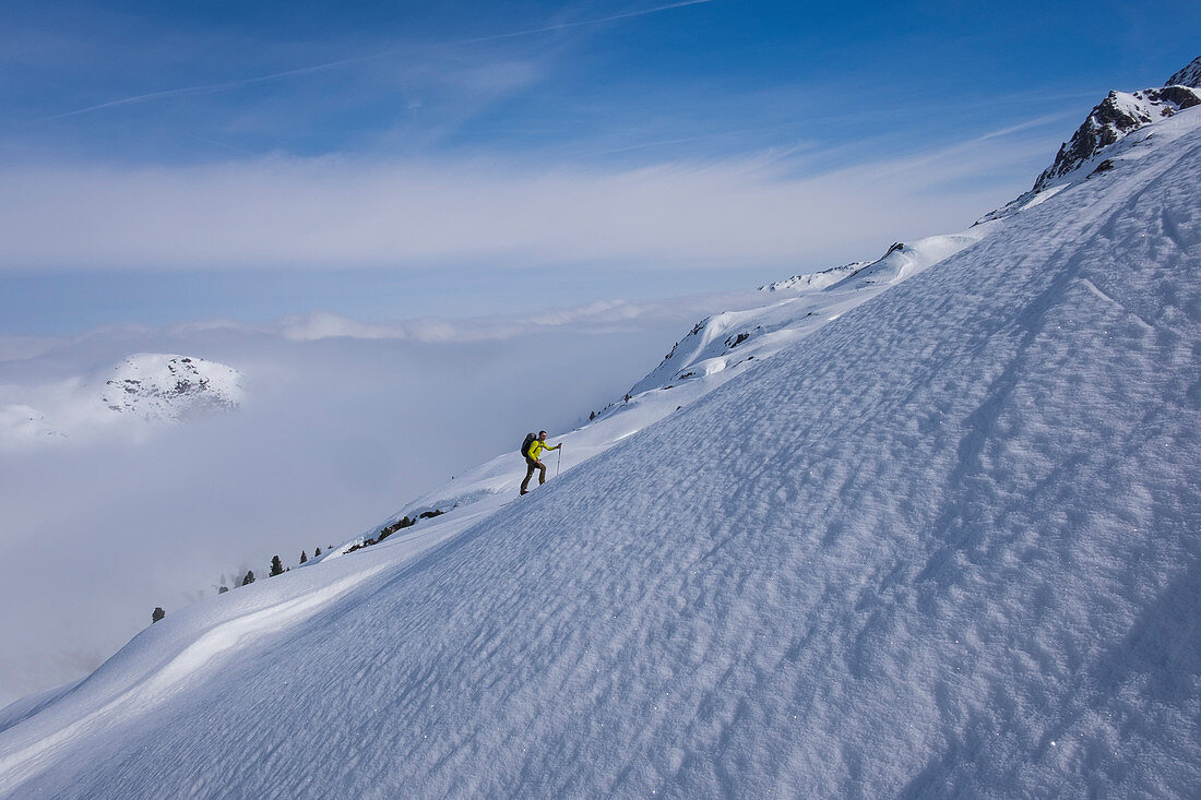 Ski tourers in the mountains of the Kitzbüheler Alpen when climbing in a steep snow field