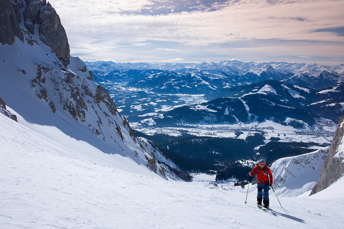 Man on ski tour at Ellmauer Tor in the Wilder Kaiser Mountains