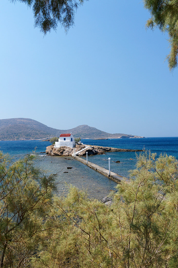 Aghios Isidhoros church set on a small Islet joined to the mainland by a narrow causway, Leros, Dodecanese Islands, Greece.                               