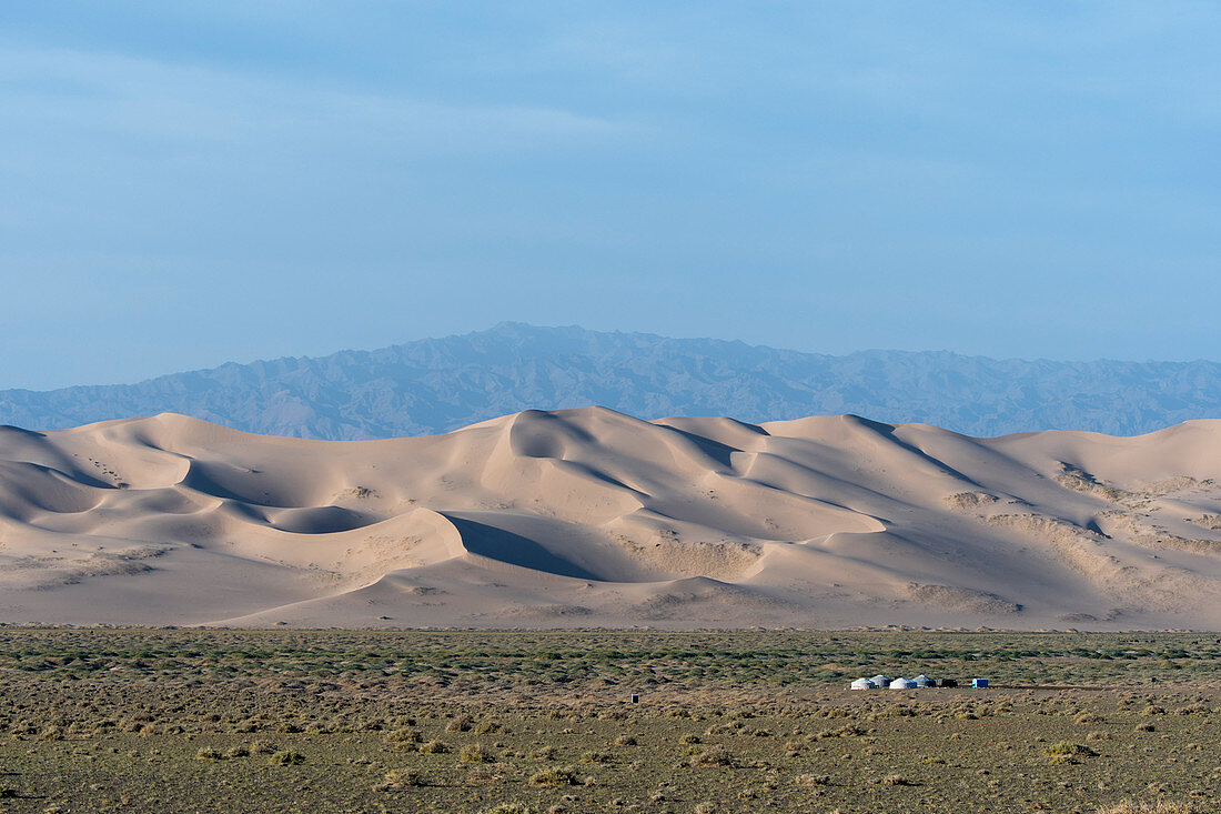 A herder ger camp in front of the Hongoryn Els sand dunes in the Gobi Desert in southern Mongolia.