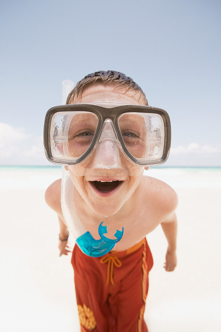 Young boy wearing goggles at the beach